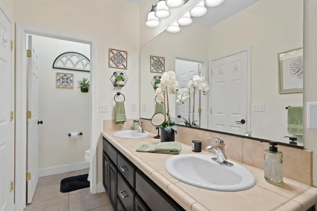 a bathroom with a double vanity sink and a mirror