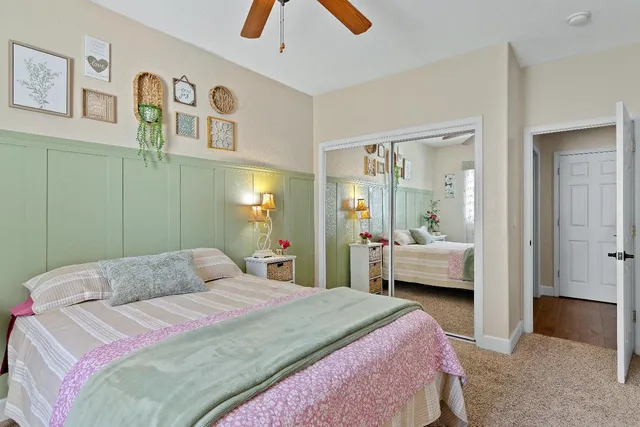 a bedroom with a bed and a chandelier