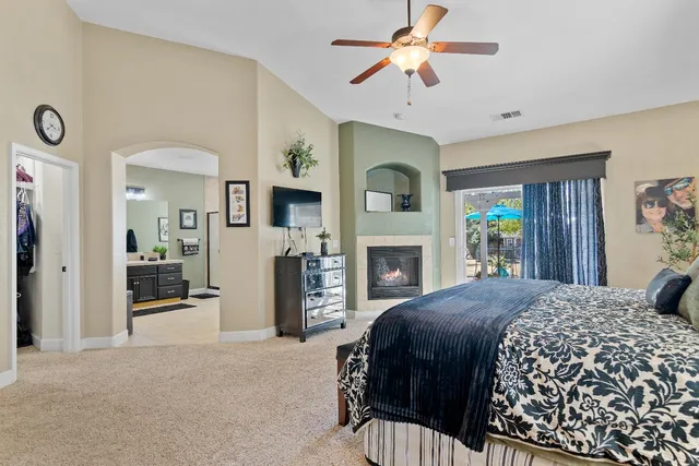 a bedroom with a bed and a television