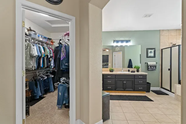 a bathroom with a tub a sink and a large mirror