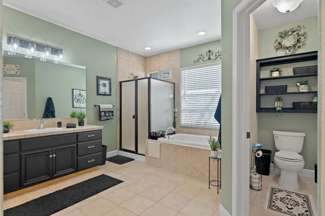 a spacious bathroom with a sink and a large mirror