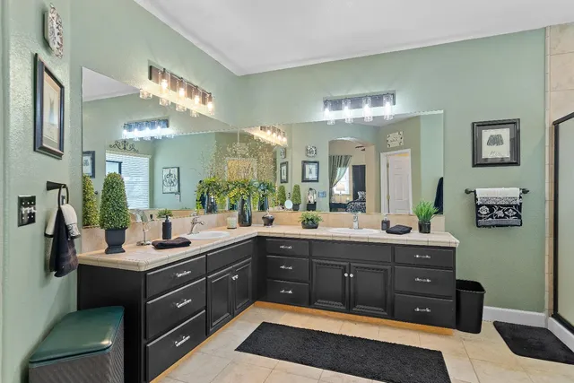 a bathroom with a double vanity sink and a mirror