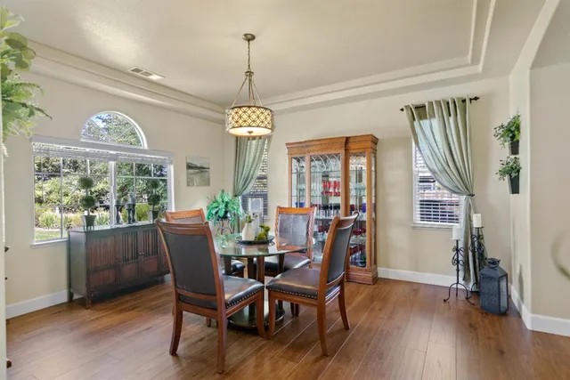 a view of a dining room with furniture window and wooden floor