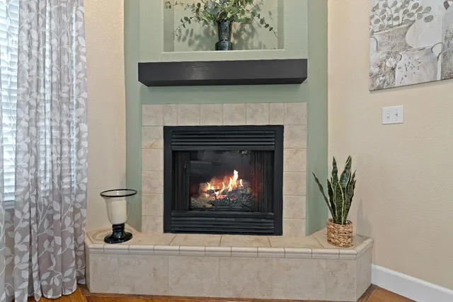 a living room with a fireplace and a painting on the wall