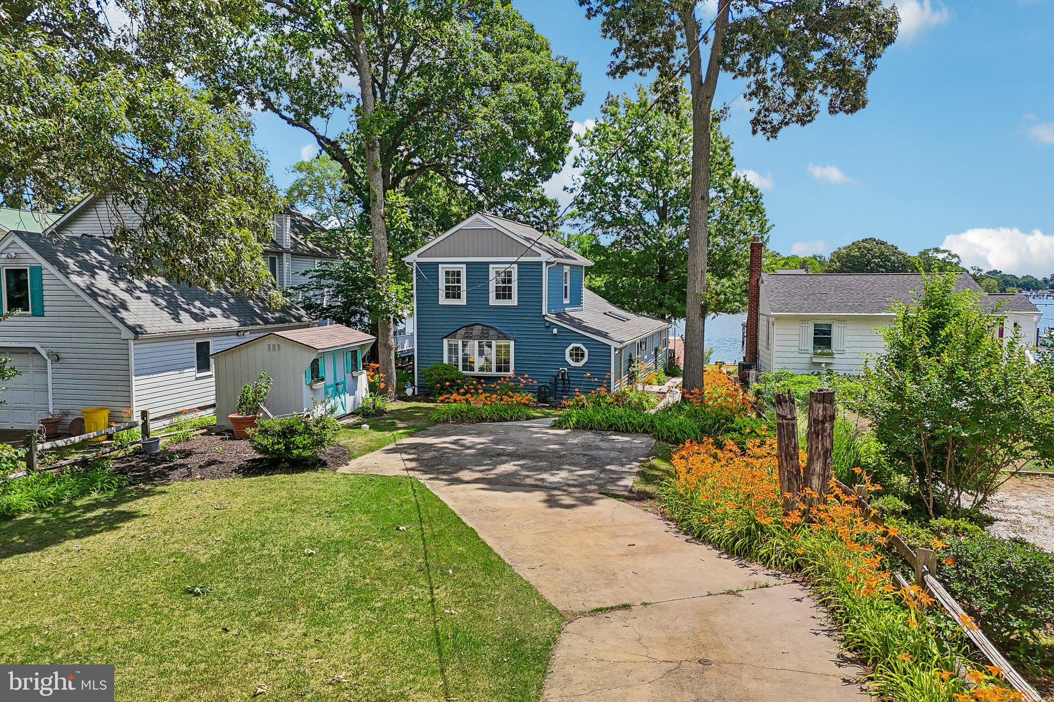 275 Gibson Road Pasadena, MD 21122 - Photo 37 of 59 Charming lakeside retreat with vibrant blooms.