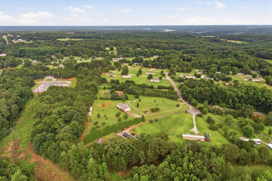 520 Sharon Lane Seneca, SC 29678 - Photo 44 of 48 An aerial perspective reveals a serene, verdant landscape with scattered homes and a distant body of water.