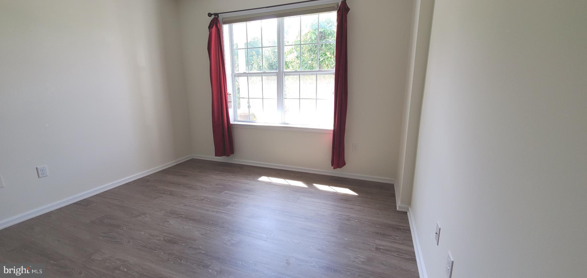 615 Timberlake Drive Ewing, NJ 08618 - Photo 12 of 22 an empty room with wooden floor and windows