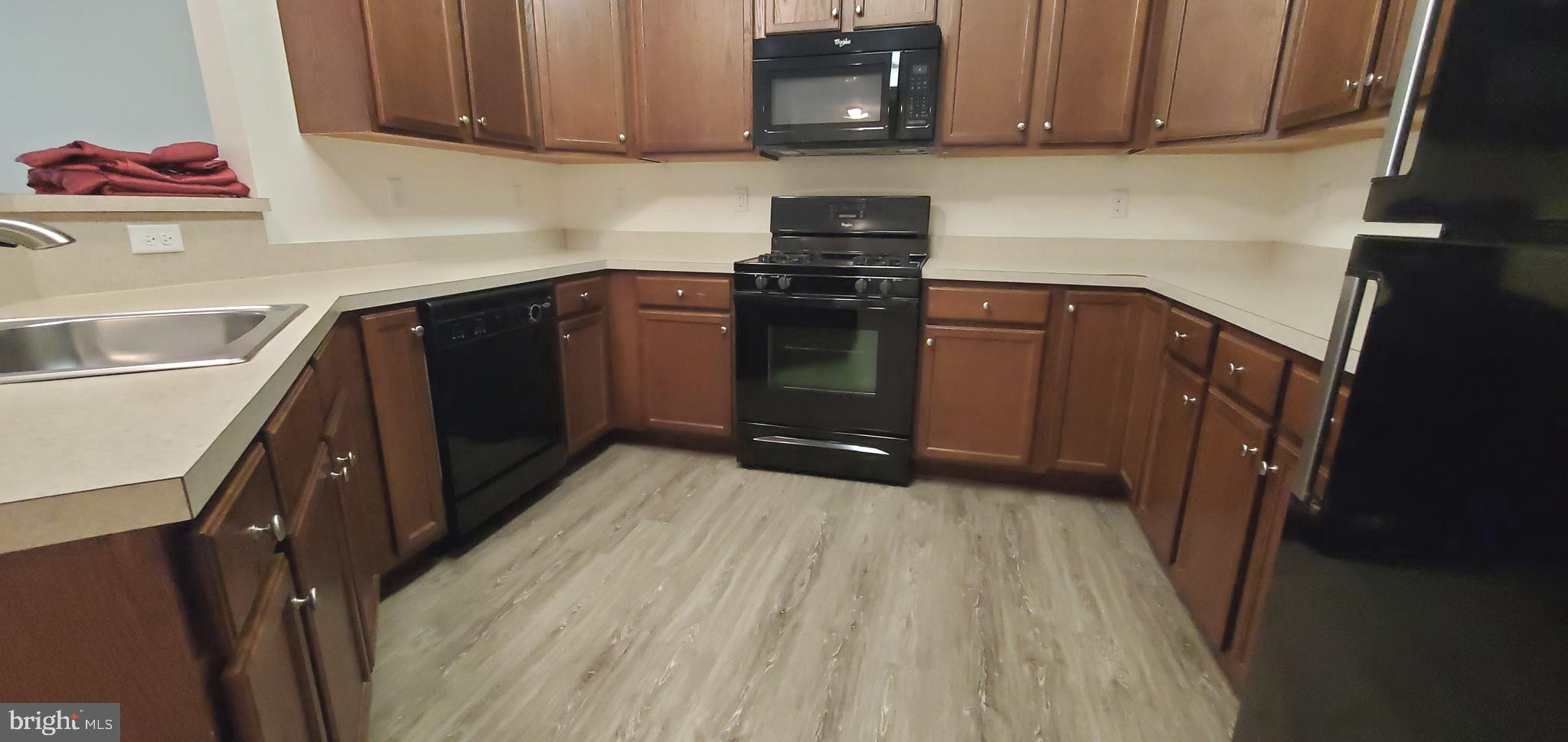 615 Timberlake Drive Ewing, NJ 08618 - Photo 2 of 22 a kitchen with a sink a stove and cabinets