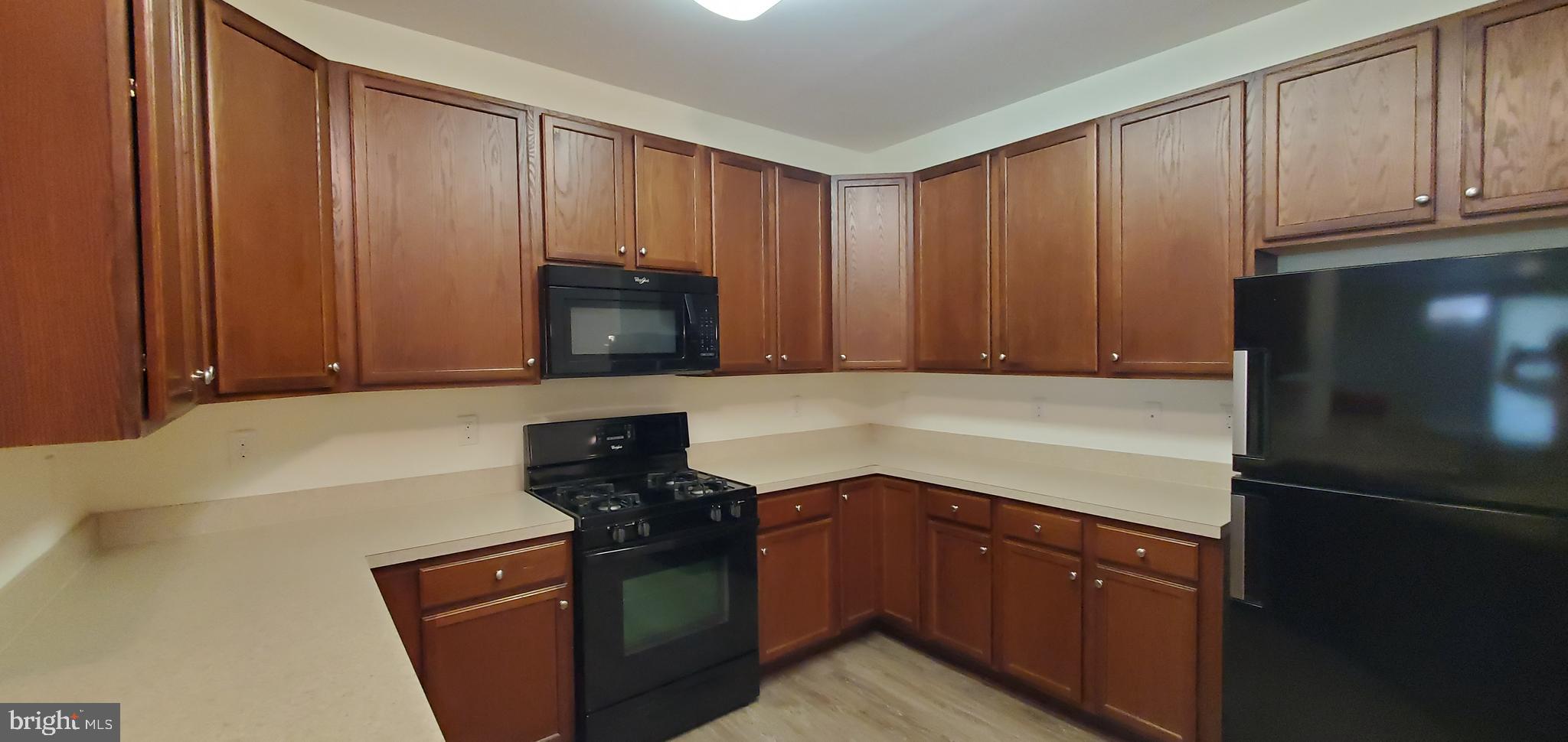 615 Timberlake Drive Ewing, NJ 08618 - Photo 3 of 22 a kitchen with granite countertop wooden cabinets and stainless steel appliances