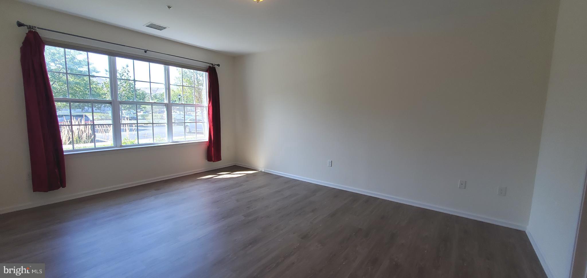 615 Timberlake Drive Ewing, NJ 08618 - Photo 7 of 22 an empty room with wooden floor and windows