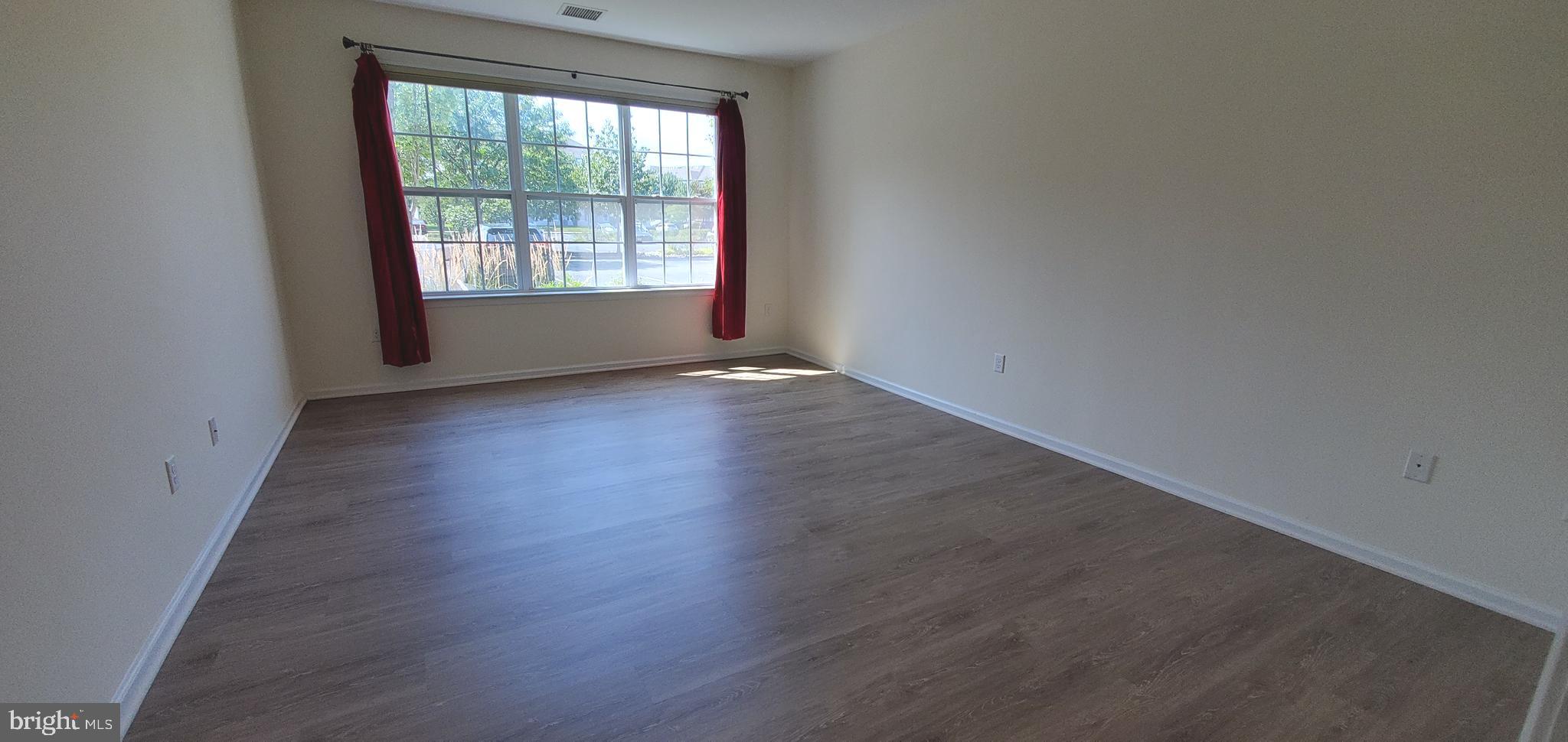 615 Timberlake Drive Ewing, NJ 08618 - Photo 8 of 22 an empty room with wooden floor and windows
