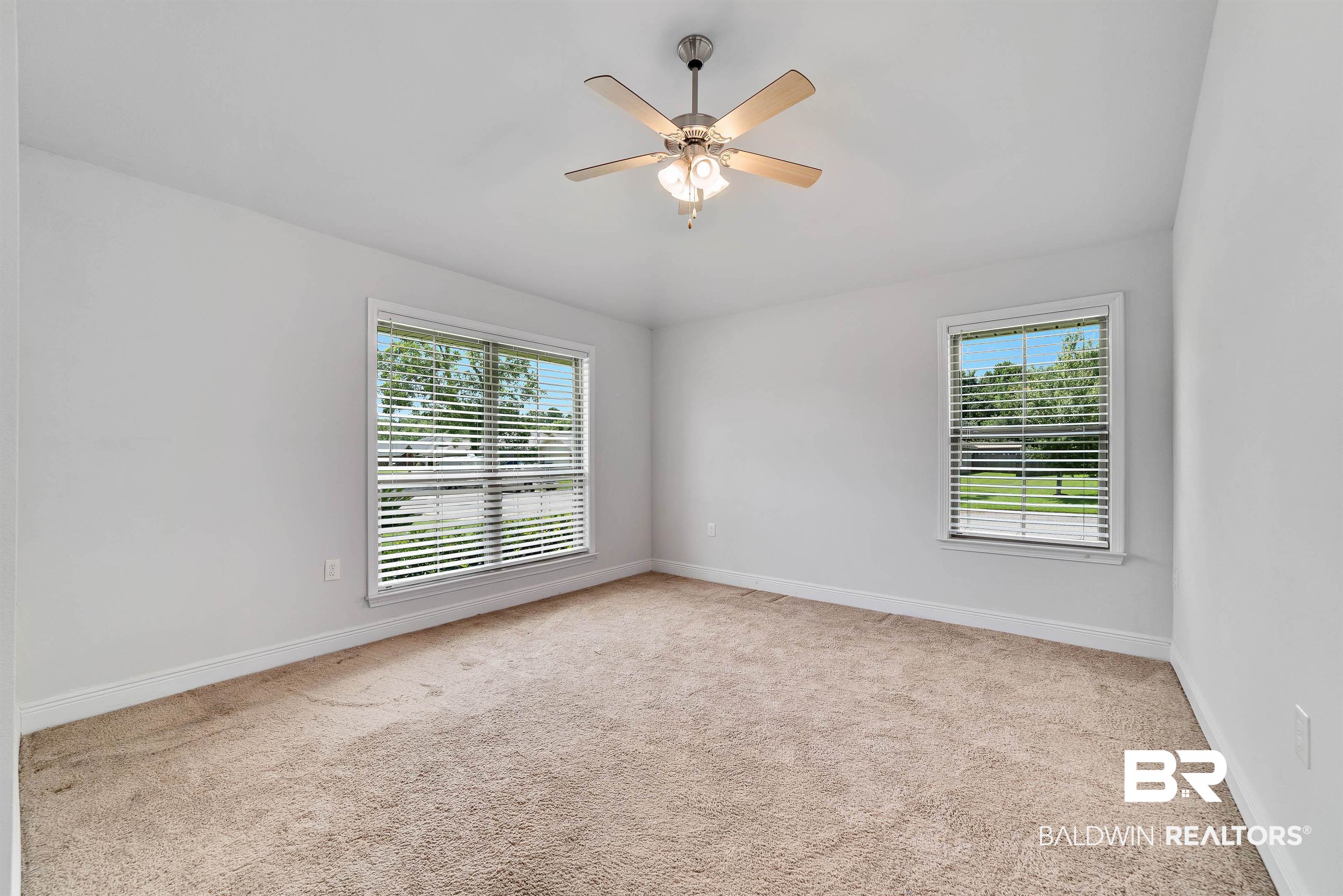 13155 Wishbone Court Foley, AL 36535 - Photo 24 of 39 Carpeted spare room featuring a wealth of natural light and ceiling fan