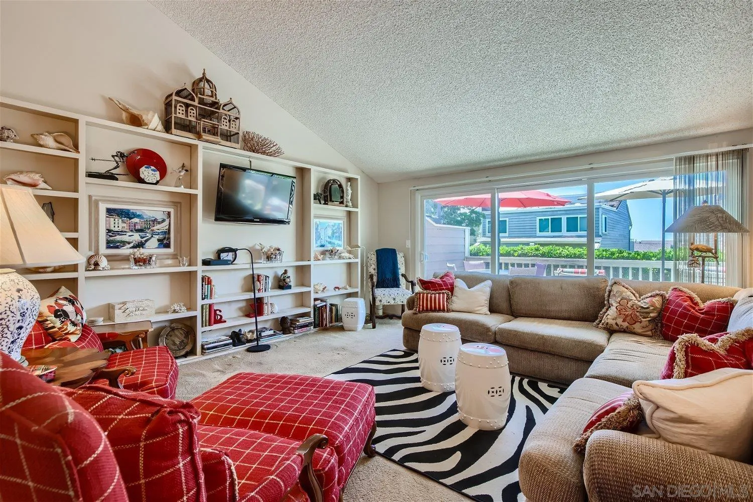 1812 Wilton Road Encinitas, CA 92024 - Photo 9 of 26 a living room with furniture a fireplace and a flat screen tv