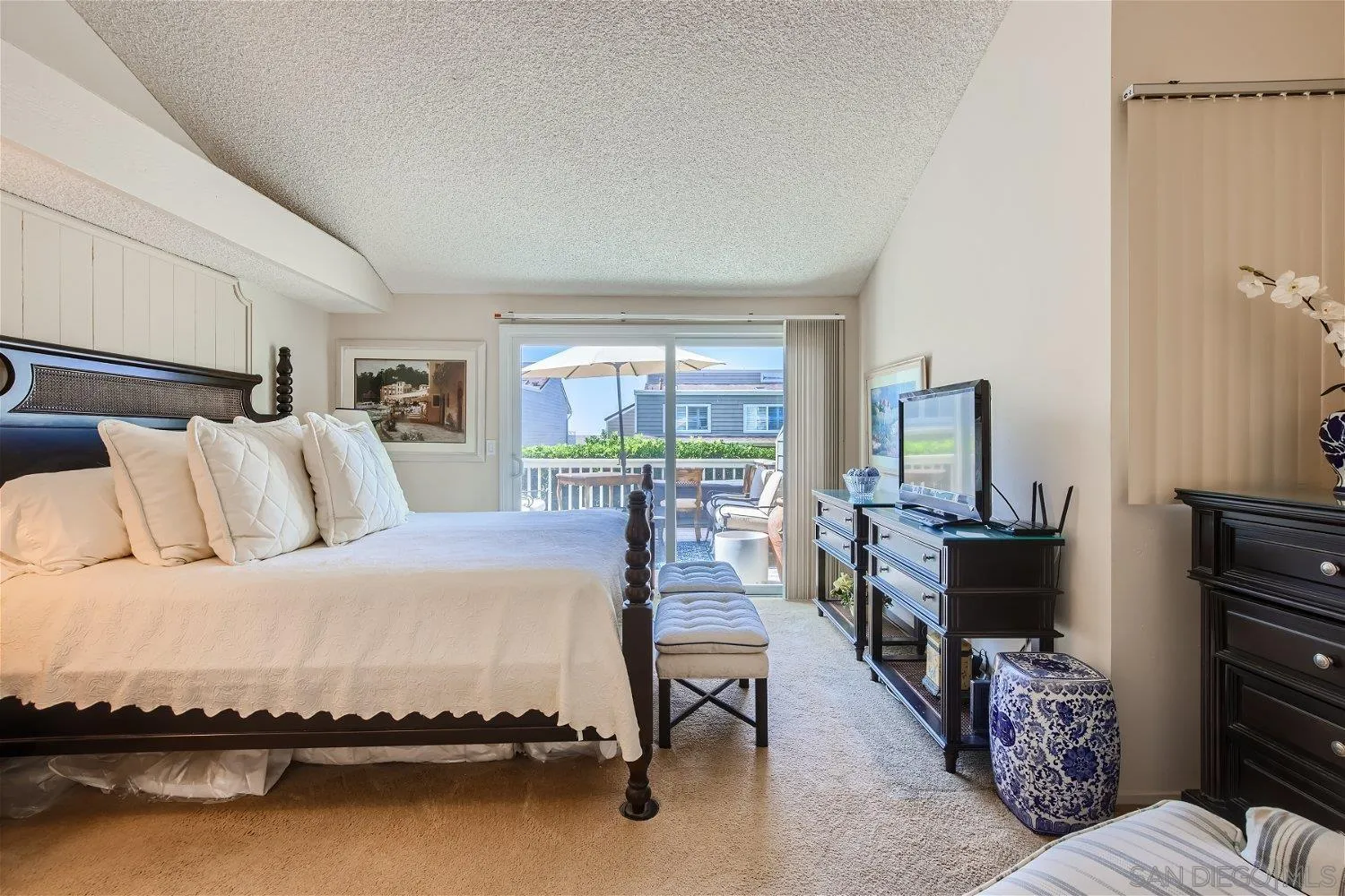 1812 Wilton Road Encinitas, CA 92024 - Photo 10 of 26 a bedroom with a bed and a flat screen tv