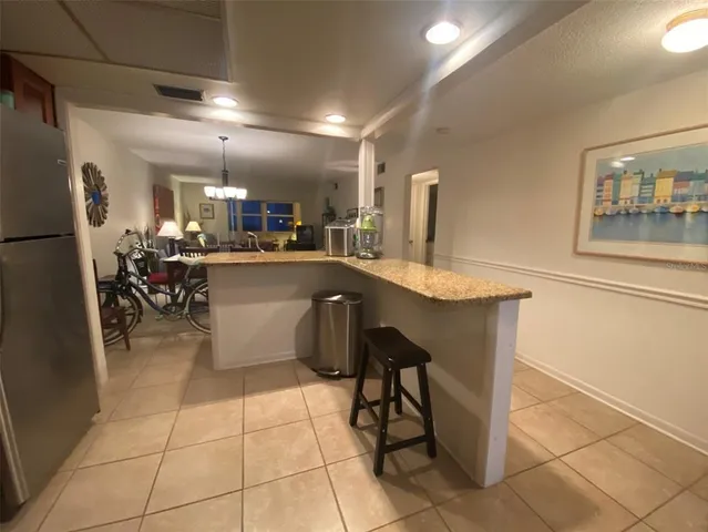 a bathroom with a granite countertop sink a toilet and a tub