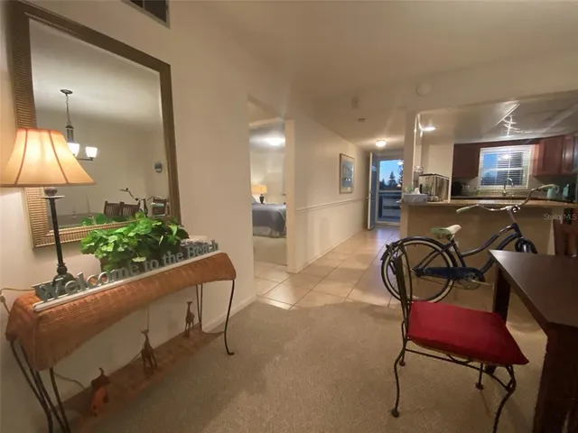 a living room with furniture and a lamp next to a window