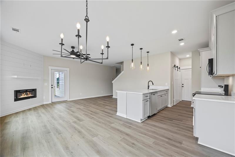 693 Racetrack Road Toccoa, GA 30577 - Photo 15 of 45 a large kitchen with sink a microwave a stove and refrigerator