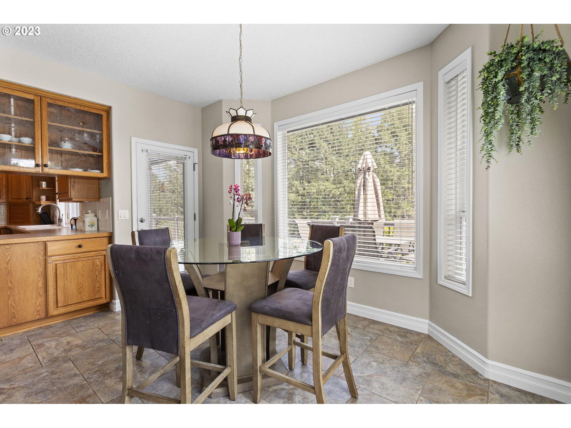 3064 South 23rd Way Ridgefield, WA 98642 - Photo 12 of 29 a dining room with furniture large windows and a chandelier