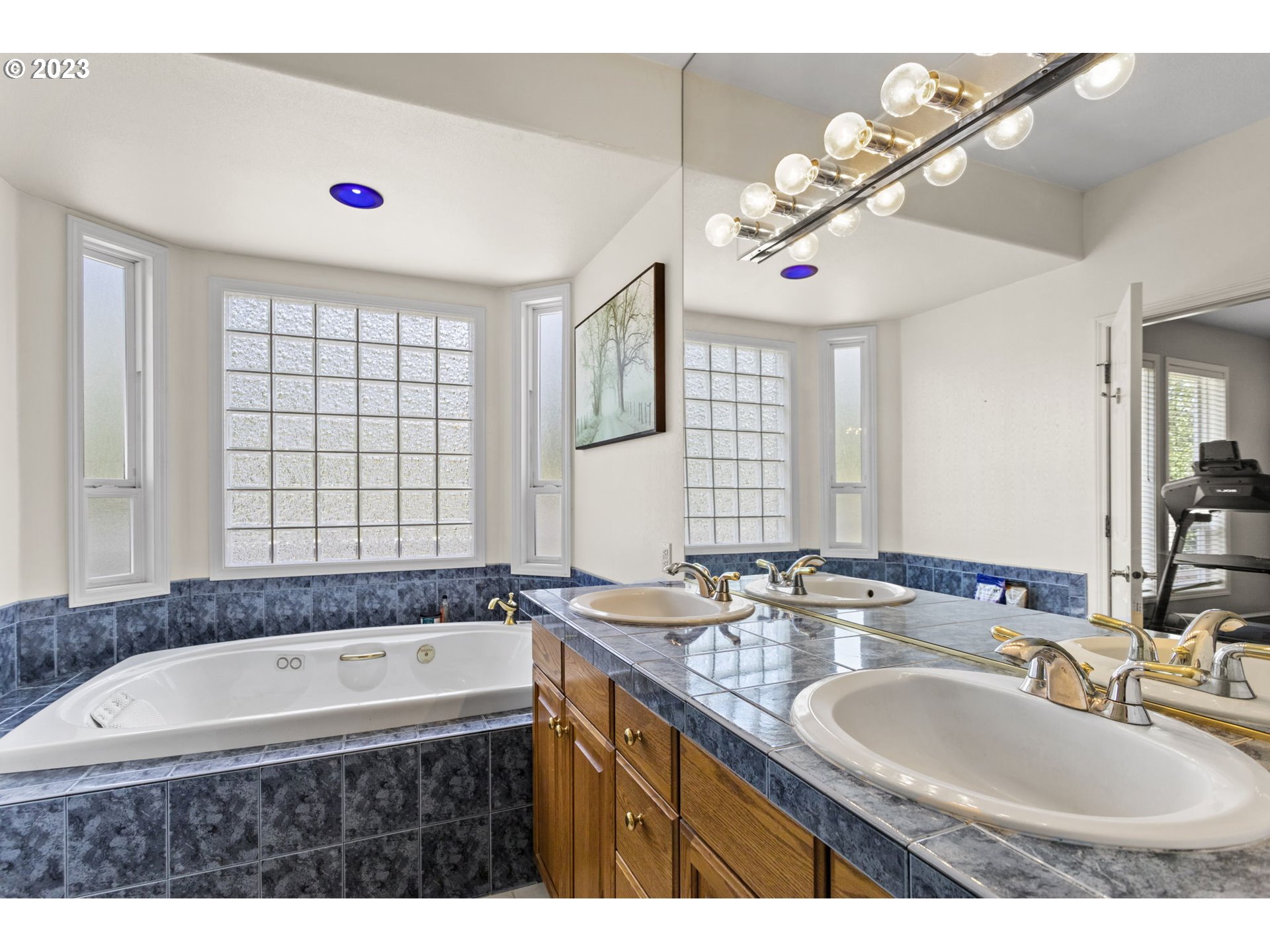 3064 South 23rd Way Ridgefield, WA 98642 - Photo 22 of 29 a bathroom with a granite countertop sink a large mirror and a bathtub