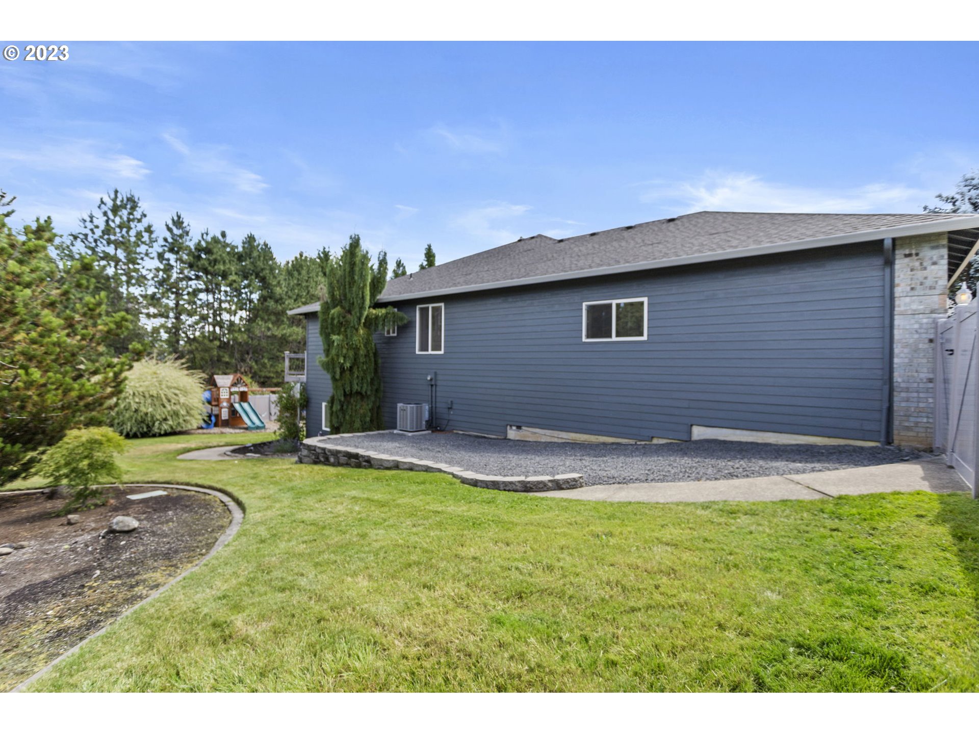 3064 South 23rd Way Ridgefield, WA 98642 - Photo 3 of 29 a backyard of a house with table and chairs