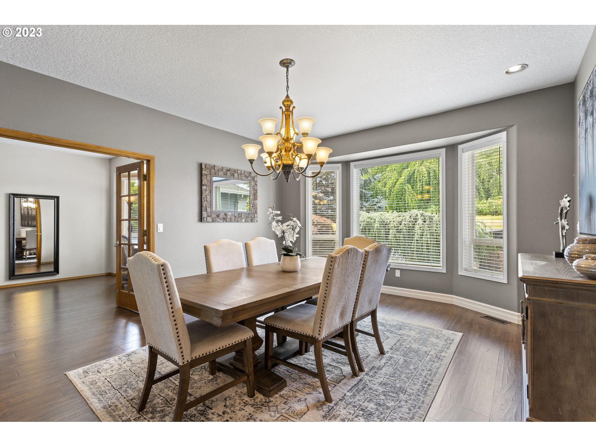 3064 South 23rd Way Ridgefield, WA 98642 - Photo 8 of 29 a dining room with furniture a chandelier and wooden floor
