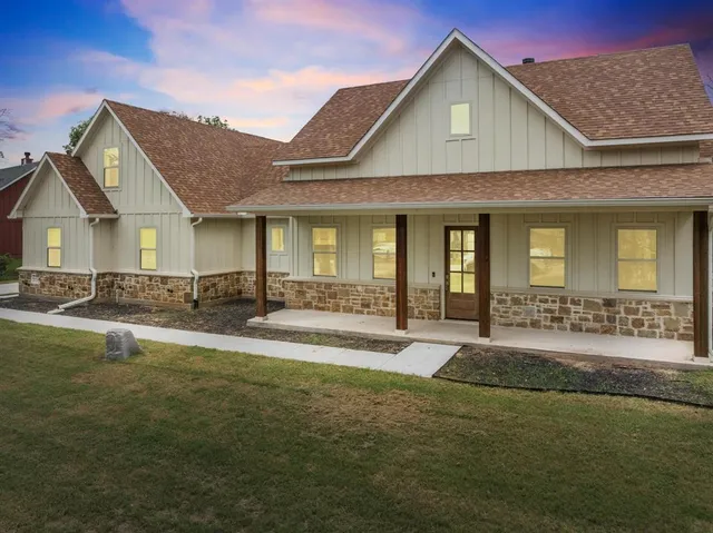 a front view of a house with swimming pool having outdoor seating