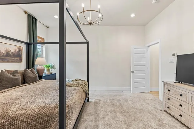 a bedroom with furniture and a flat screen tv