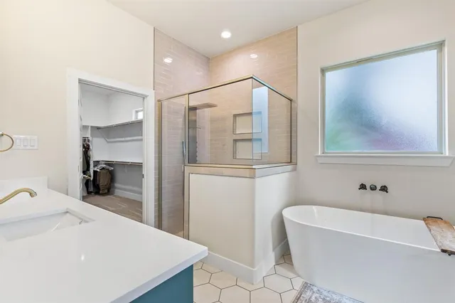 a bathroom with a bathtub and a sink