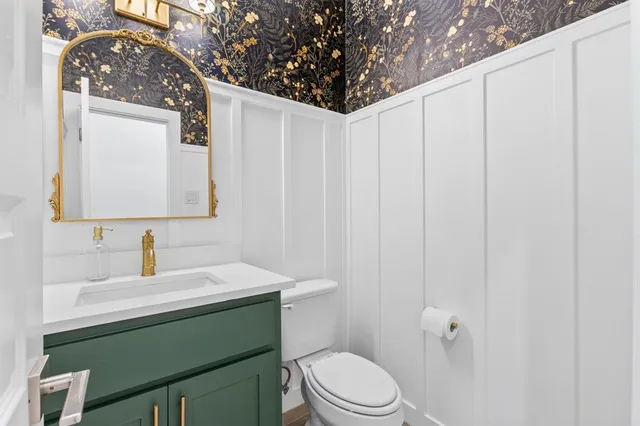 a bathroom with a sink toilet and mirror