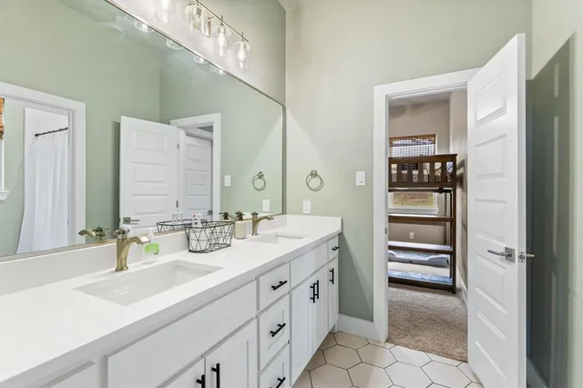 a spacious bathroom with a double vanity sink and a mirror