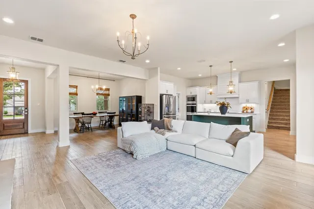 a living room with furniture and kitchen view