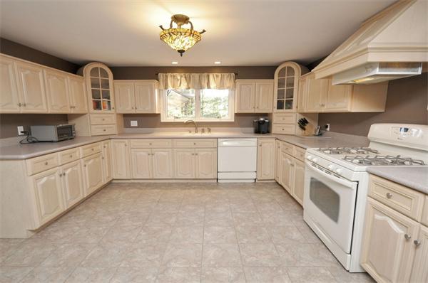 4 Wilmor Road Topsfield, MA 01983 - Photo 10 of 29 a kitchen with white cabinets and white appliances