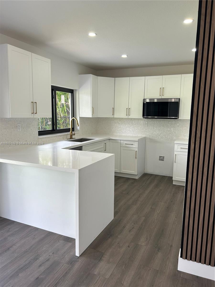 a kitchen with a sink and a stove top oven