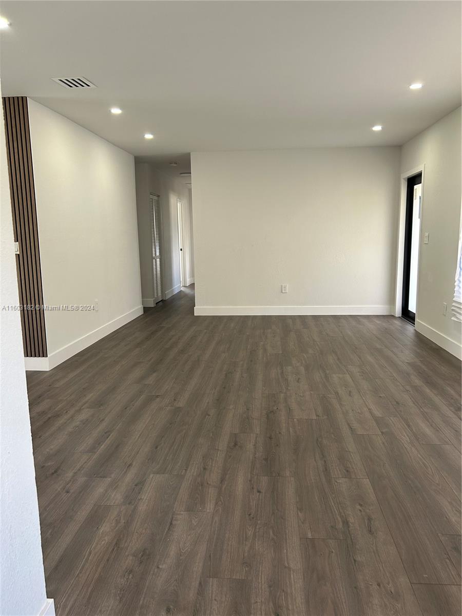 Westchester Miami, FL 33165 - Photo 11 of 14 a view of an empty room with wooden floor and a window