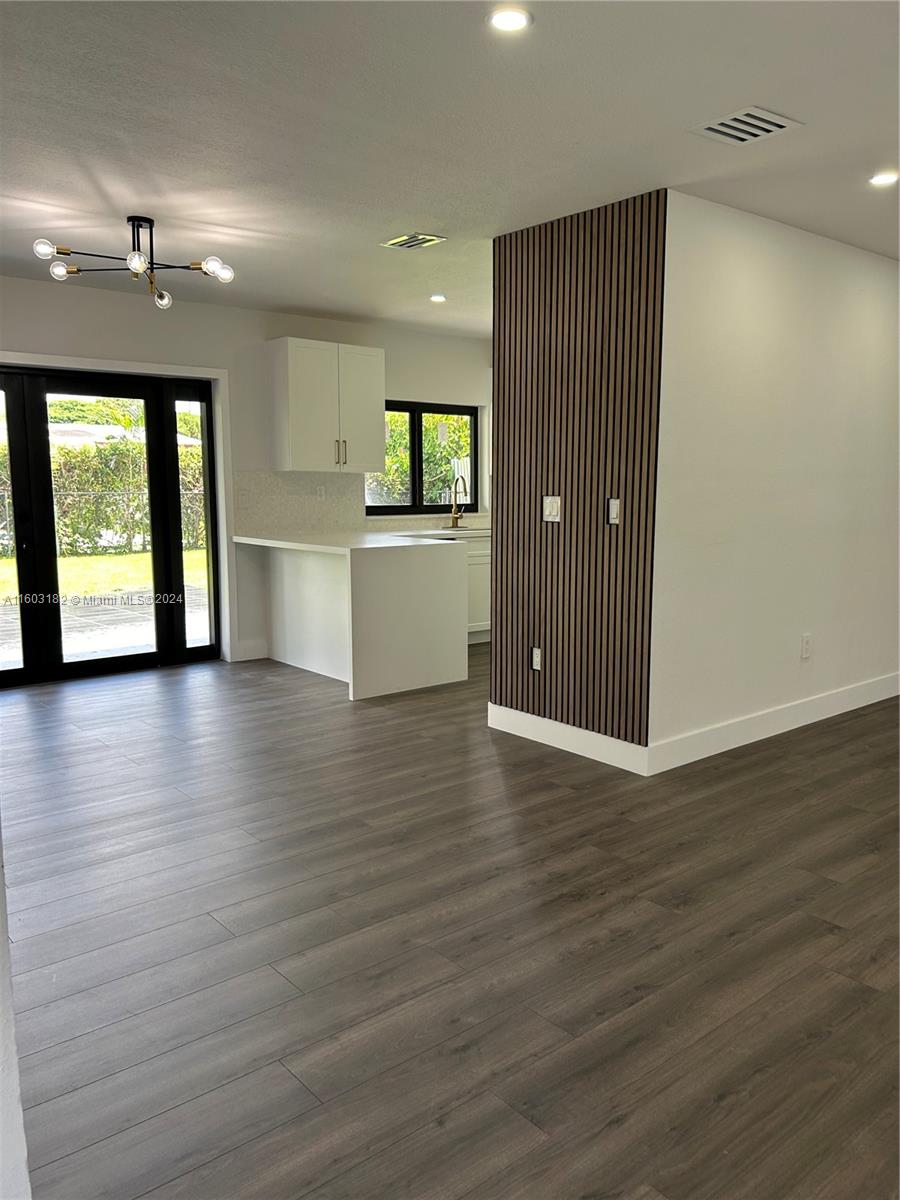Westchester Miami, FL 33165 - Photo 2 of 14 a view of an empty room with wooden floor and a window