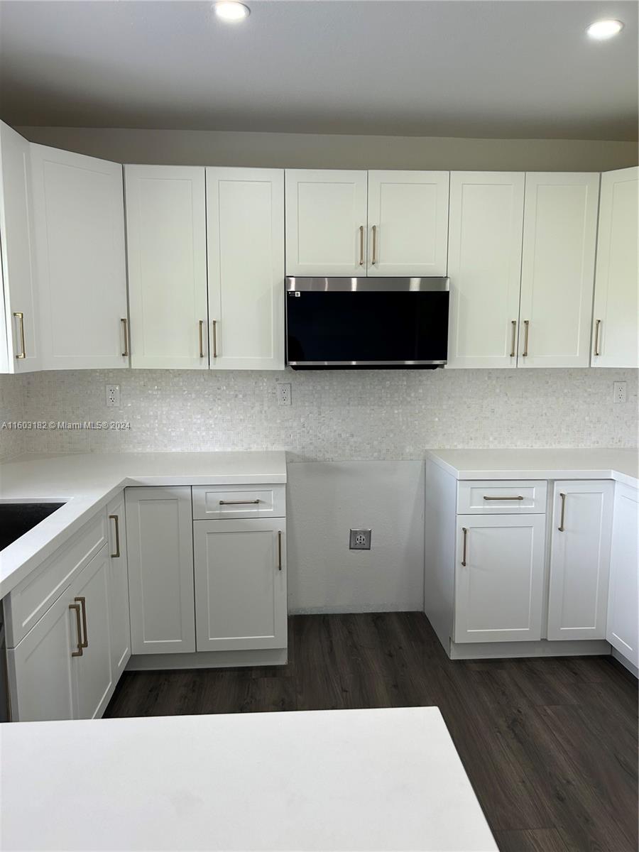 Westchester Miami, FL 33165 - Photo 3 of 14 a kitchen with a cabinets and a stove with wooden floor