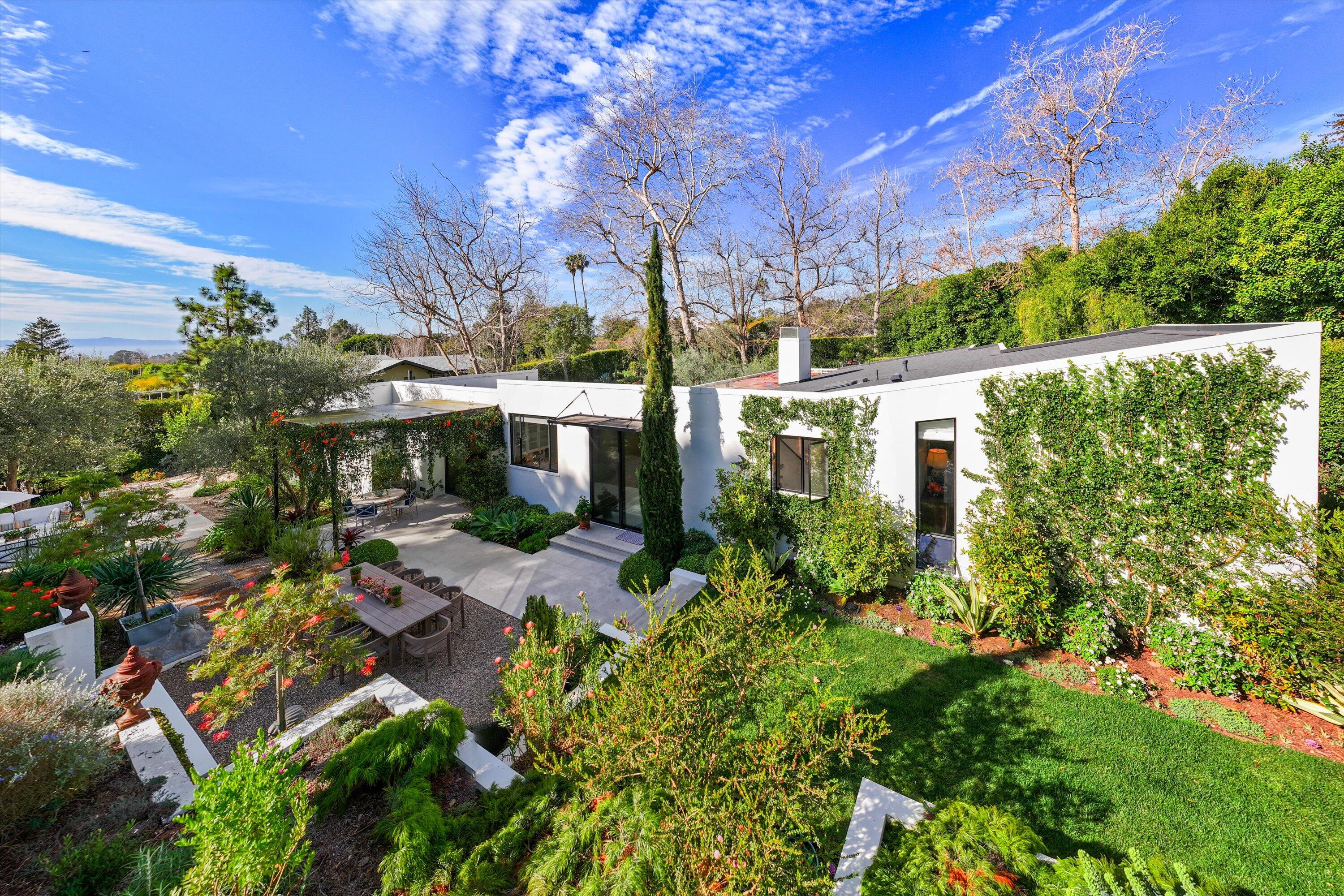 a view of backyard with plants and outdoor seating