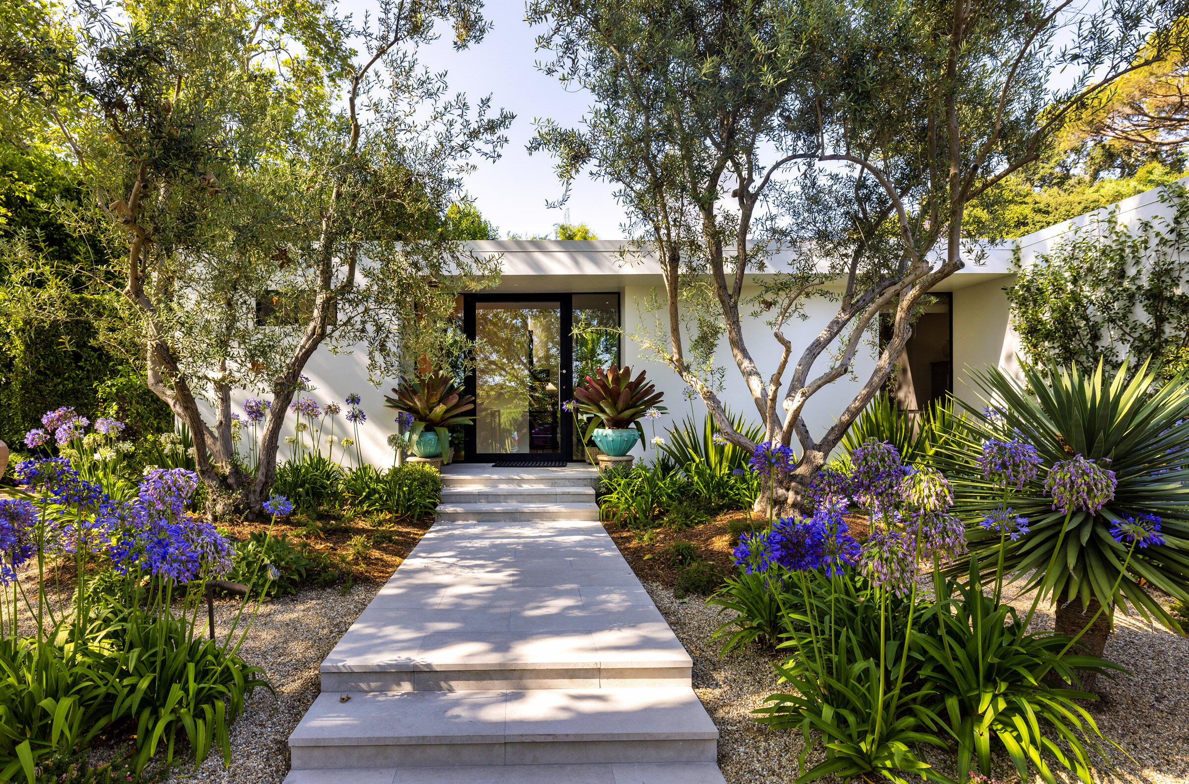 448 Court Place Montecito, CA 93108 - Photo 4 of 33 a front view of a house with a yard and fountain in middle