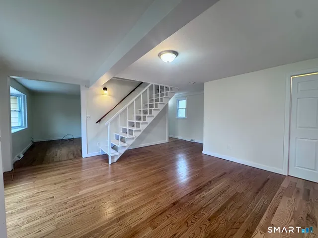 a view of an entryway with wooden floor