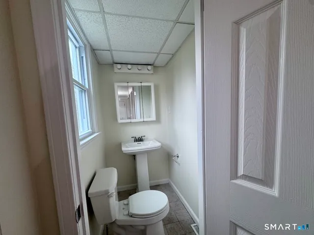 a white toilet sitting next to a bathroom sink
