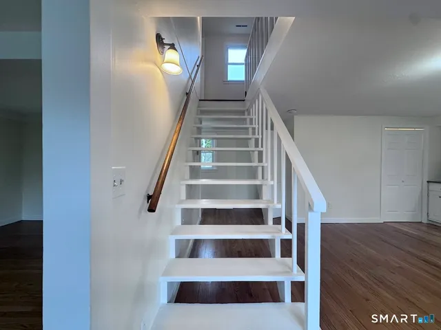 a view of entryway and hall with wooden floor