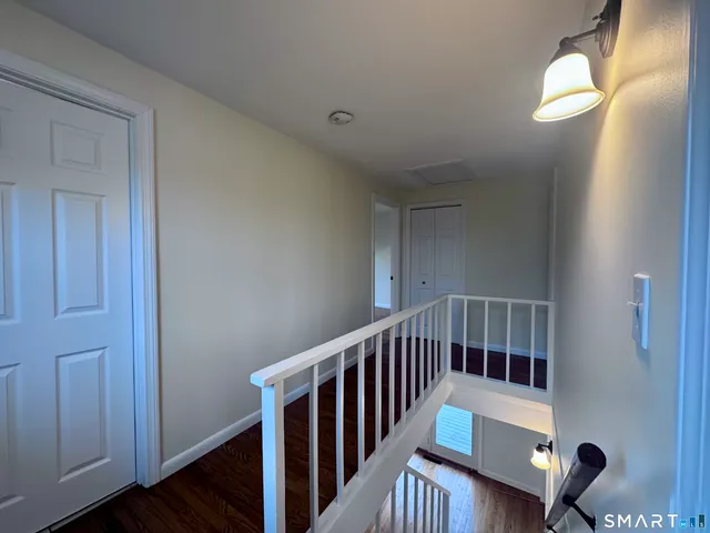 a view of hallway with wooden floor
