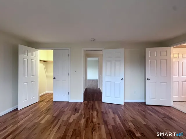 a view of wooden floor and windows in a room
