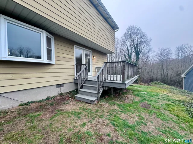 a view of a house with a yard and wooden fence