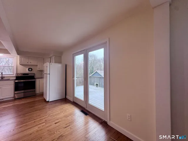 a kitchen with a refrigerator and a stove top oven