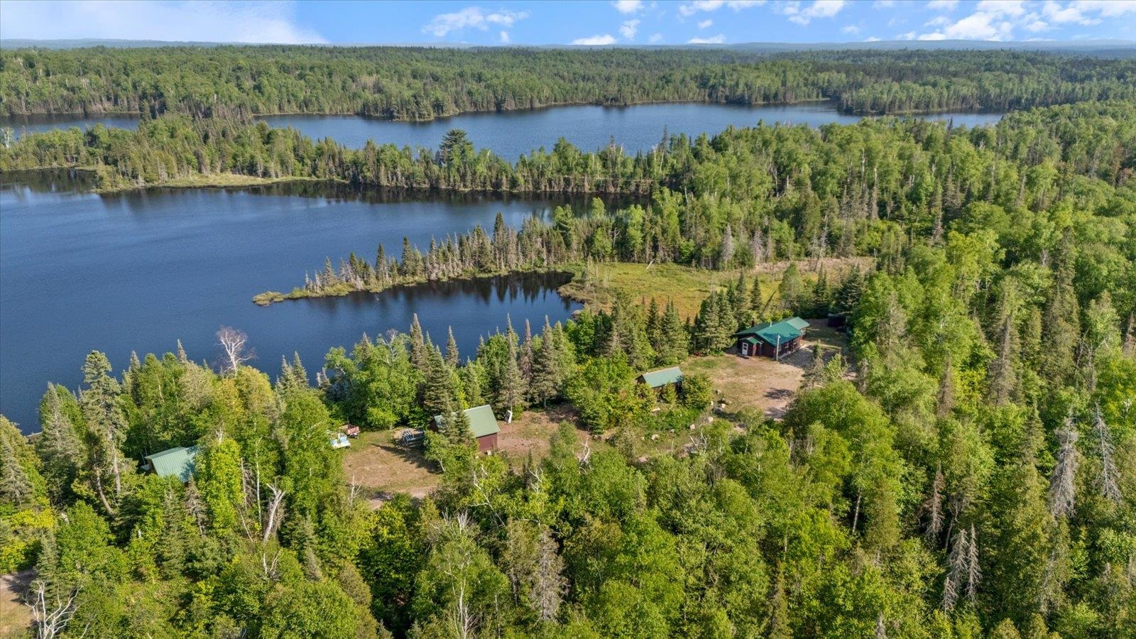 9420 Vollmer Drive Isabella, MN 55607 - Photo 2 of 37 Aerial view of property and surrounding area featuring a forest and a large body of water