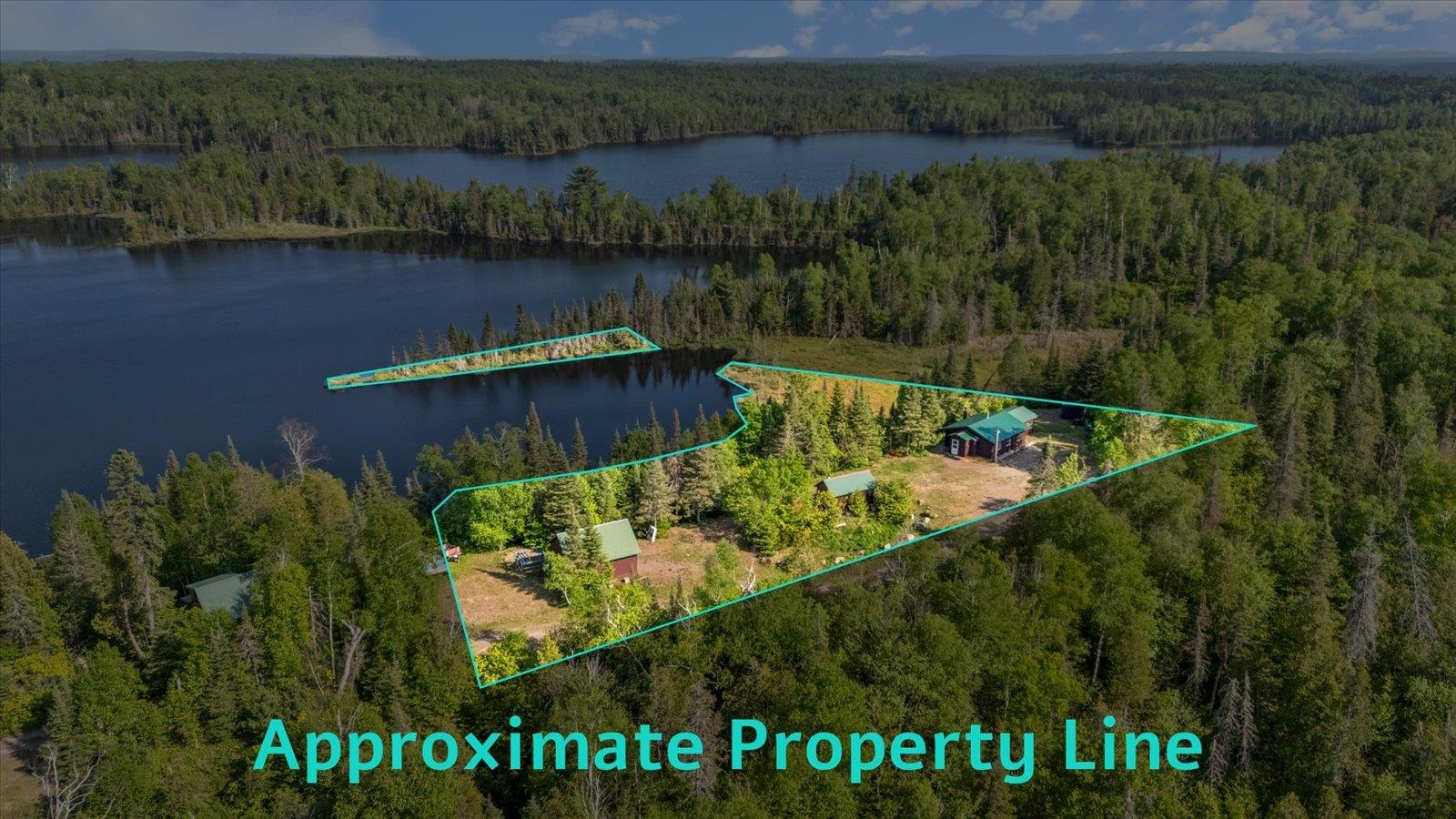 9420 Vollmer Drive Isabella, MN 55607 - Photo 3 of 37 Aerial view of property and surrounding area featuring a heavily wooded area, a large body of water, and property parcel outlined