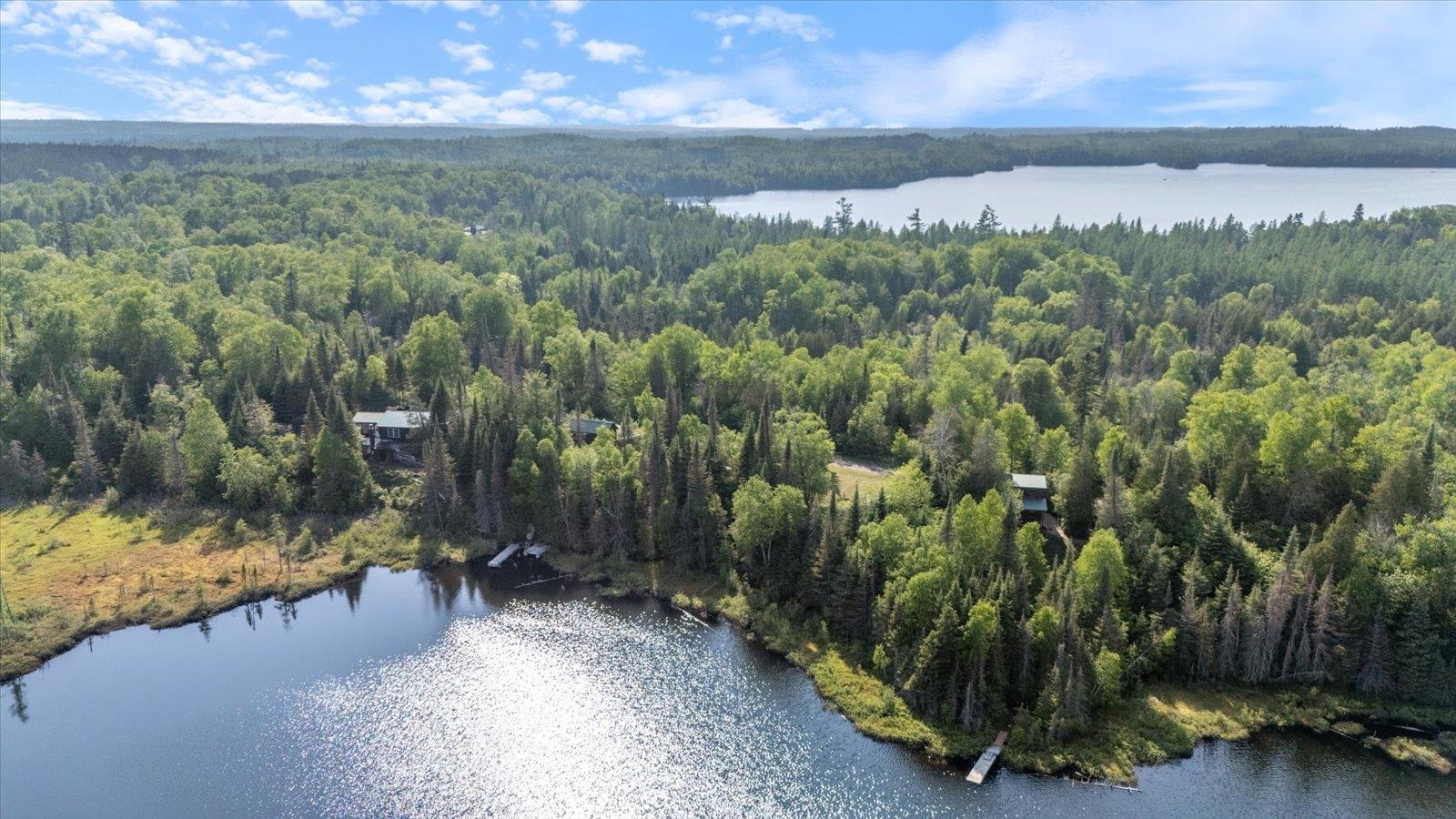 9420 Vollmer Drive Isabella, MN 55607 - Photo 5 of 37 Aerial view of a heavily wooded area and a large body of water