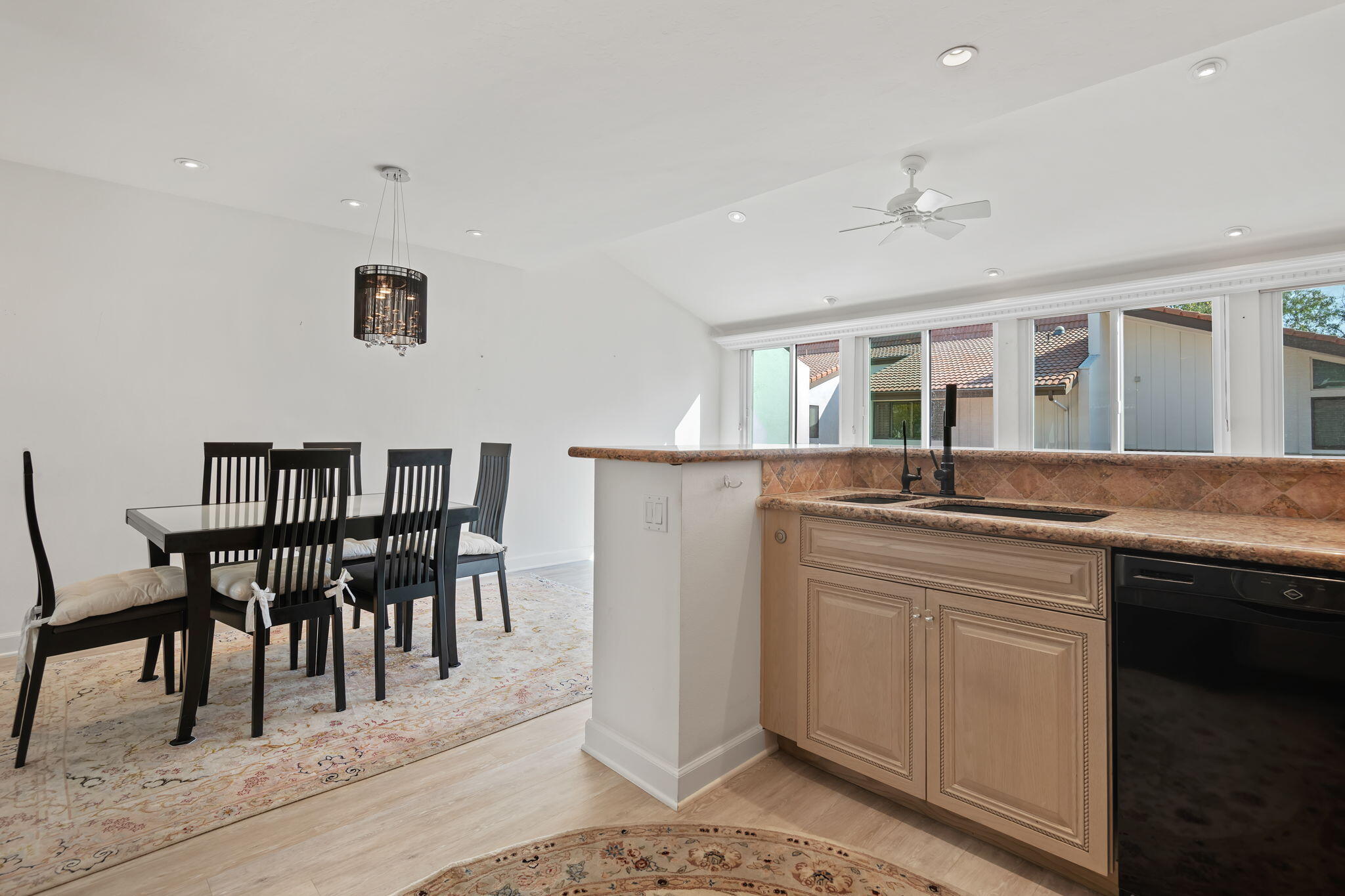 659 Del Parque Drive, Unit E Santa Barbara, CA 93103 - Photo 11 of 32 a kitchen with kitchen island granite countertop a sink and white cabinets