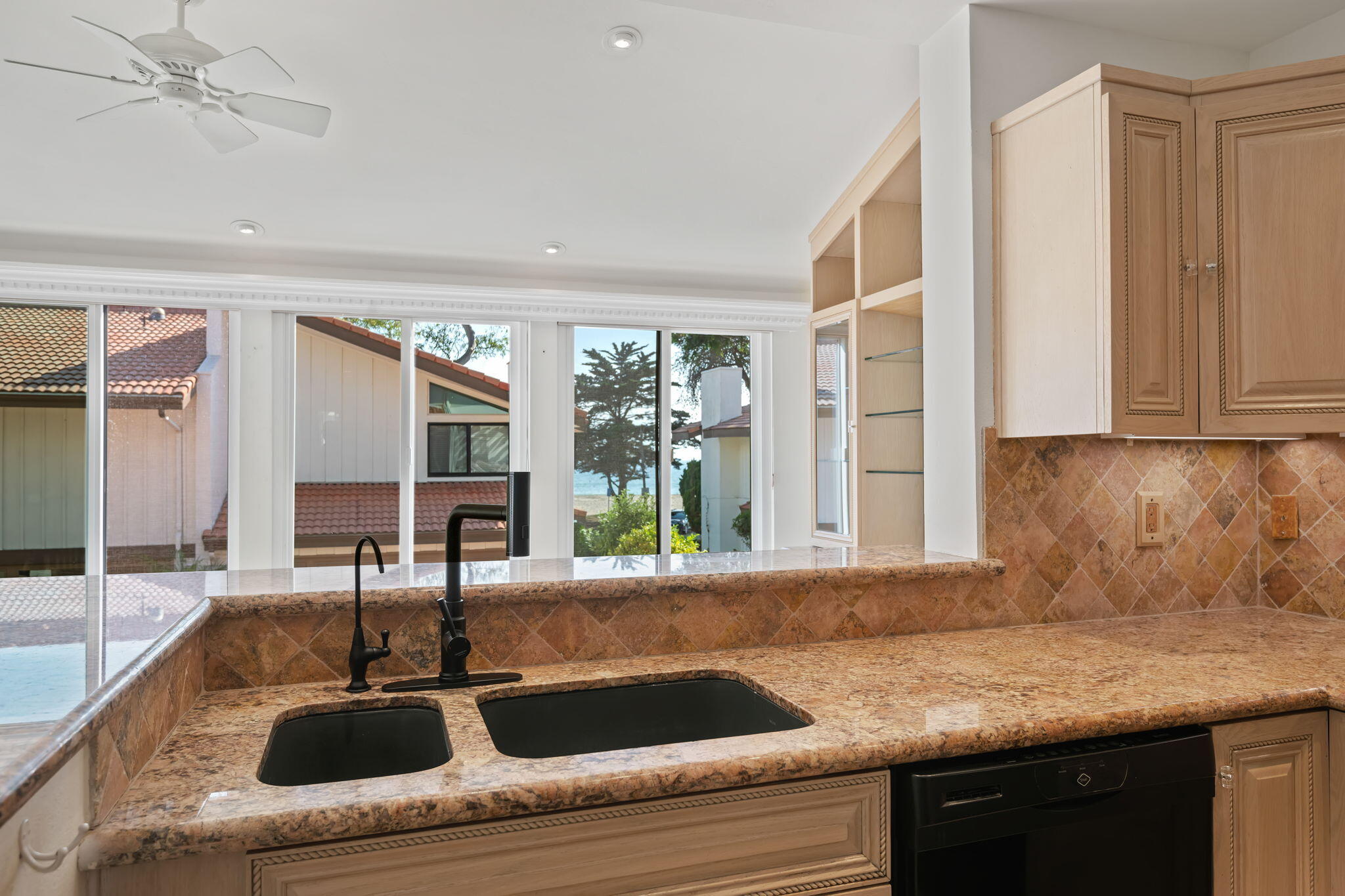 659 Del Parque Drive, Unit E Santa Barbara, CA 93103 - Photo 12 of 32 a kitchen with granite countertop a sink and a window